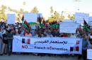 Libyan protesters hold banners and placards during a demonstration to protest against the French military intervention in the country on July 20, 2016 on Martyrs' Square in the capital Tripoli