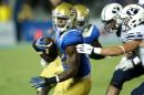Linebacker Myles Jack (L) of the UCLA Bruins, ranked one of the five best players in the draft by NFLDraftScout.com, missed most of last season at UCLA after undergoing knee surgery