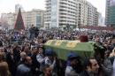 People carry the coffin of former Lebanese minister Mohamad Chatah's bodyguard Tarek Badr, who was killed in a bomb blast on Friday, during his mass funeral at al-Amin mosque in Martyrs' Square in downtown Beirut