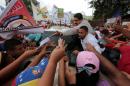 Venezuela's President Nicolas Maduro greets supporters as he arrives for his weekly broadcast "En contacto con Maduro" (In contact with Maduro) in La Victoria