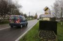 A French National Gendarmerie car drives past the road sign at the entry of Le Bosc-Roger-en-Roumois, northern France