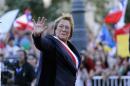 Chile's new president Michelle Bachelet waves to the crowd as she arrives at the La Moneda presidential palace after being sworn into office, in Santiago