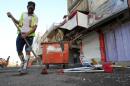 A worker sweeps the pavement in the Karrada district of Baghdad on October 18, 2013, a day after a car bomb attack outside a restaurant