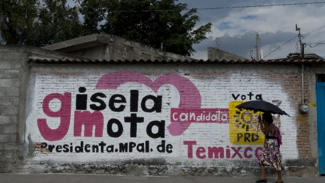 A woman walks by an electoral campaign mural of Gisela Mota, the mayor who was gunned down a day after taking office in Temixco, Morelos State, Mexico on January 4, 2016