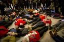 Demonstrators stage a 'die-in' in a protest against the grand jury decision in the Eric Garner case during rush hour at Grand Central Terminal in New York
