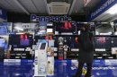 A man looks at Panasonic TV sets at an electronic shop in Tokyo