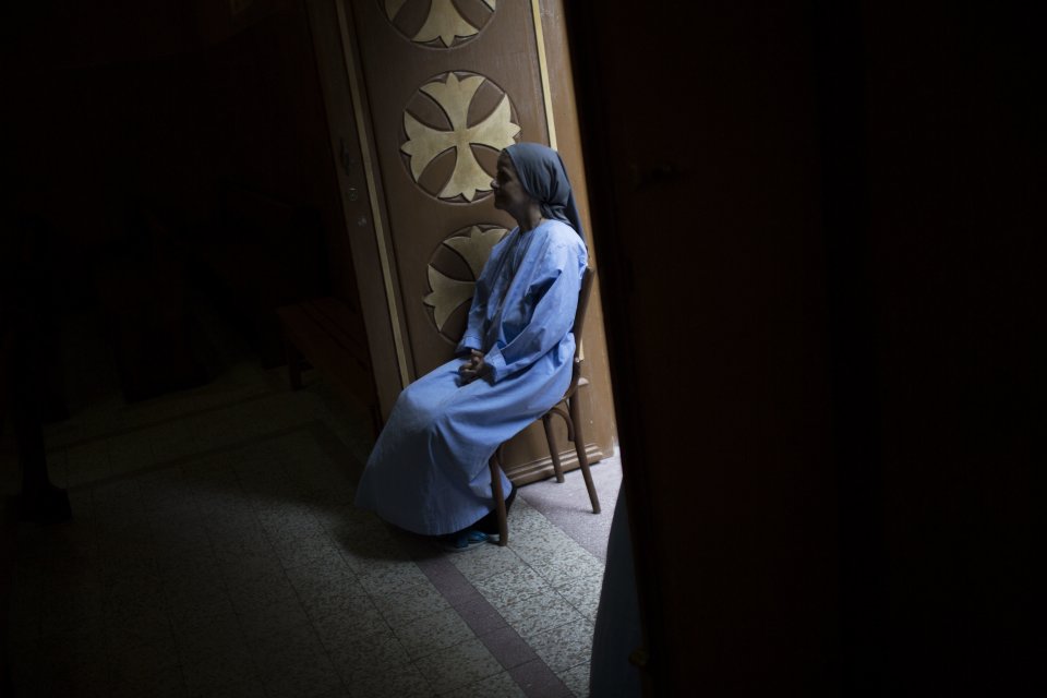 A Coptic nun attends prayer at a church within Al-Mahraq monastery in Assiut, Upper Egypt, Tuesday, Aug. 6, 2013. Islamists may be on the defensive in Cairo, but in Egypt's deep south they still have much sway and audacity: over the past week, they have stepped up a hate campaign against the area's Christians. Blaming the broader Coptic community for the July 3 coup that removed Islamist president Mohammed Morsi, Islamists have marked Christian homes, stores and churches with crosses and threatening graffiti. (AP Photo/Manu Brabo)