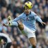 Manchester City's Tevez jumps for the ball during their English Premier League soccer match against Tottenham Hotspur in Manchester