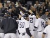 New York Yankees' Raul Ibanez celebrates with teammates as he reaches home plate after hitting the game-winning home run during the 12th inning of Game 3 of the American League division baseball series against the Baltimore Orioles on Wednesday, Oct. 10, 2012, in New York. The Yankees 3-2. (AP Photo/Kathy Willens)