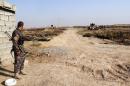 Iraqi security forces and Turkmen Shiite fighters hold a position on August 4, 2014 in Amerli