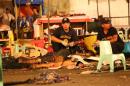 Philippine police investigators check bodies at a blast site at a night market that has left at least several people dead and wounded others in southern Davao city, Philippines late Friday Sept. 2, 2016. The powerful explosion at a night market late Friday in Philippine President Rodrigo Duterte's hometown in the southern Philippines took place amid a security alert due to a major offensive against Abu Sayyaf militants in the region, officials said. (AP Photo/Manman Dejeto)