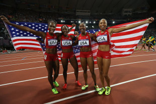 Carmelita Jeter, Bianca Knight, Allyson Felix, and Tianna Madison celebrate after winning the Women&#39;s 4 x 100m Relay Final (Getty Images)