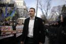 Klitschko walks past supporters and police outside parliament in Kiev
