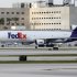In this Thursday, Oct. 11, 2012 photo, a FedEx cargo jet taxis on the runway after landing at Miami International Airport in Miami. FedEx says its third-quarter profit fell 31 percent as customers are opting for less-expensive ground shipping, hurting the company's airfreight business. (AP Photo/Wilfredo Lee)