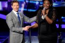 Host Ryan Seacrest (left) and contestant Candice Glover onstage at FOX's American Idol Season 12 Top 4 To 3 Live Performance Show on Wednesday, May 1, 2013 in Hollywood, California. (Photo by Frank Micelotta/Invision for FOX/AP Images)