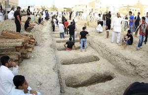Shi&#39;ite Muslims prepare graves during a mass funeral &hellip;