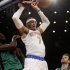New York Knicks' Carmelo Anthony dunks over Boston Celtics' Jeff Green, left, and Shavlik Randolph during the first half of the NBA basketball game at Madison Square Garden, Sunday, March 31, 2013, in New York. (AP Photo/Seth Wenig)