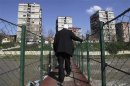A man walks over a bridge in the ethnically divided town of Mitrovica