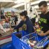 Erica Avegalio, center, and her brother Albert Avegalio, right, load up on water and food at the Times Supermarket after learning of a tsunami warning Saturday, Oct. 27, 2012, in Honolulu.  A tsunami warning has been issued for Hawaii after a 7.7-magnitude earthquake rocked an island off the west coast of Canada. The Pacific Tsunami Warning Center originally said there was no threat to the islands, but a warning was issued later Saturday and remains in effect until 7 p.m. Sunday. A small craft advisory is in effect until Sunday morning. (AP Photo/Eugene Tanner)