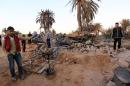 Libyans gather next to debris at the site of a jihadist training camp, targeted in a US air strike, near the Libyan city of Sabratha on February 19, 2016