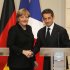 German Chancellor Angela Merkel, left, and France's President Nicolas Sarkozy, right, shake hands at the end of their joint news conference at the Elysee Palace, Paris, Monday, Dec. 5, 2011. Sarkozy and Merkel sought Monday to present a unified plan to tighten oversight of government budgets - a key step ahead of a European Union summit later this week to try to save the euro. (AP Photo/Michel Euler)