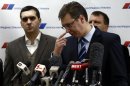 Serbian Progressive Party (SNS) leader and Serbian defence Minister Vucic gestures during a media conference in his party's headquarters in Belgrade