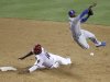Los Angeles Dodgers shortstop Dee Gordon, right, leaps to avoid the slide by Arizona Diamondbacks' Justin Upton, left, to complete a double play for the final outs of the game in the ninth inning of a baseball game Tuesday, May 22, 2012, in Phoenix. The Dodgers won 8-7.(AP Photo/Paul Connors)
