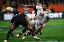 England's Manu Tuilagi (C) is tackled during a rugby union test match in Dunedin on June 14, 2014