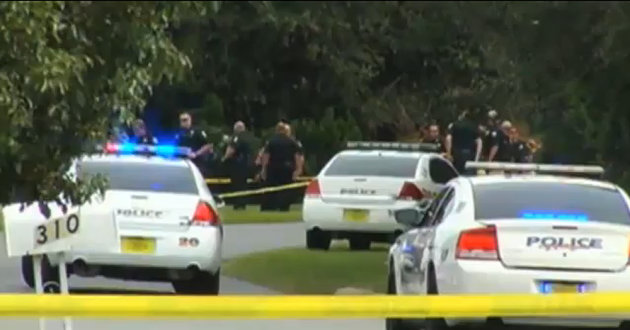 In this Sunday, Sept. 30, 2012 image made from video and provided by WKMG-TV, authorities investigate the scene of a shooting, in Winter Springs, Fla. Authorities in central Florida say two members of a motorcycle club died and a third was critically injured when gunfire erupted in the parking lot of a Veterans of Foreign War post Sunday morning as a charity ride was getting under way. (AP Photo/WKMG-TV)