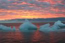 FILE - In this Sept. 13, 2006 file photo, ice chunks float in the Arctic Ocean as the sun sets near Barrow, Alaska. The Arctic is a thermostat against overheating and a barometer of change, but now its own protective ozone layer that keeps out damaging ultraviolet radiation has thinned to record levels, the U.N. weather agency said Tuesday April 5, 2011. (AP Photo/Arctic Sounder, Beth Ipsen)