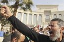 A supporter of Egypt's President Mursi gestures during a rally in front of the Supreme Constitutional Court in Maadi, south of Cairo