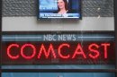 The news ticker outside the Today Show announces GE's sale of NBC to Comcast, in New York