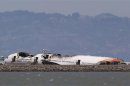 The charred remains of the Asiana Airlines flight 214 sits on the runway at San Francisco International Airport in San Francisco, California