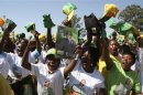 Supporters of Zimbabwean President Robert Mugabe's ZANU-PF party cheer during an election rally in Chitungwiza