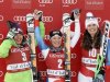 Second placed Smith of the U.S., winner Gut of Switzerland and her third placed team mate Kamer react on the podium after the Women's World Cup Downhill skiing race in Val d'Isere