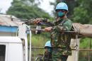 UN peacekeepers wear a face mask to protect themselves from the Ebola virus as they patrol in Kandopleu, Ivory Coast, on August 14, 2014 near the border with Guinea and Liberia