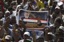 Members of the Muslim Brotherhood and supporters of deposed Egyptian President Mohamed Mursi attend a funeral for two people killed in recent clashes at Rabaa Adawiya Square, where they are camping in Nasr city area