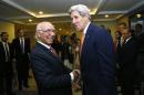 US Secretary of State John Kerry is greeted by Pakistan's National Security Advisor Sartaj Aziz (L) shortly after arriving in Islamabad on January 12, 2015