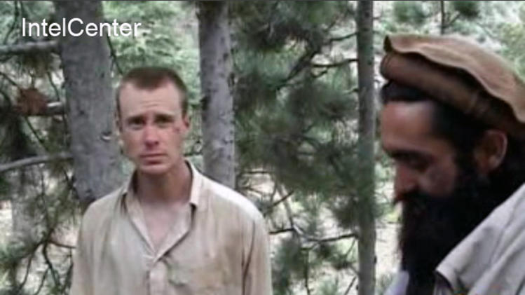FILE - This file image provided by IntelCenter on Dec. 8, 2010, shows a frame grab from a video released by the Taliban containing footage of a man believed to be Bowe Bergdahl, left. Saturday, May 31, 2014, U.S. officials say Bergdahl, the only American soldier held prisoner in Afghanistan has been freed and is in U.S. custody. The officials say his release was part of a negotiation that includes the release of five Afghan detainees held in the U.S. prison at Guantanamo Bay, Cuba. (AP Photo/IntelCenter, File) MANDATORY CREDIT: INTELCENTER; NO SALES; EDS NOTE: "INTELCENTER" AT LEFT TOP CORNER ADDED BY SOURCE