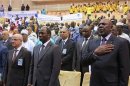 Diarra, Bassole and Medelci stand at attention for the national anthem before the start of a high level international meeting in Bamako