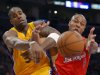 Los Angeles Lakers forward Antawn Jamison, left, and Los Angeles Clippers forward Caron Butler battle for a loose ball during the first half of their NBA basketball game, Thursday, Feb. 14, 2013, in Los Angeles.  (AP Photo/Mark J. Terrill)