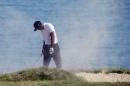 Tiger Woods covers his face after hitting from a bunker on the fourth holeduring the second round of the PGA Championship golf tournament Friday, Aug. 14, 2015, at Whistling Straits in Haven, Wis. (AP Photo/Brynn Anderson)