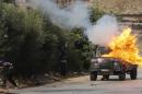 An Israeli border police jeep is hit by a molotov cocktail thrown by Palestinian protesters during clashes near the Jewish settlement of Bet El, near the West Bank city of Ramallah