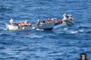 Migrants sit in a boat during a rescue operation off the coast of Sicily in early December