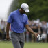 Tiger Woods looks at his wrist after a shot on the first hole during the first round of the U.S. Open golf tournament at Merion Golf Club, Thursday, June 13, 2013, in Ardmore, Pa. (AP Photo/Gene J. Puskar)