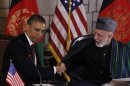 President Barack Obama and Afghan President Hamid Karzai shake hands after making statements before signing a strategic partnership agreement at the presidential palace in Kabul, Afghanistan, Wednesday, May 2, 2012. (AP Photo/Charles Dharapak)