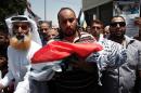 Relatives carry the body of 18-month-old Palestinian toddler Ali Saad Dawabsha, who died after his house was set on fire by Jewish settlers, during his funeral in the West Bank village of Duma on July 31, 2015