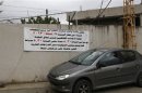 A banner erected on a wall placing a curfew on all "foreigners from 8:30pm to 5:30am" Botchai southern Beirut,