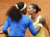 Pennetta of Italy kisses Williams of U.S. as she abandons the match following an injury during the Rome Masters tennis tournament