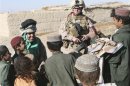 U.S. Marine Corp handout photo of 2nd Lt. Carly E. Towers interacting with children during a patrol through Tajik Khar in Garmsir